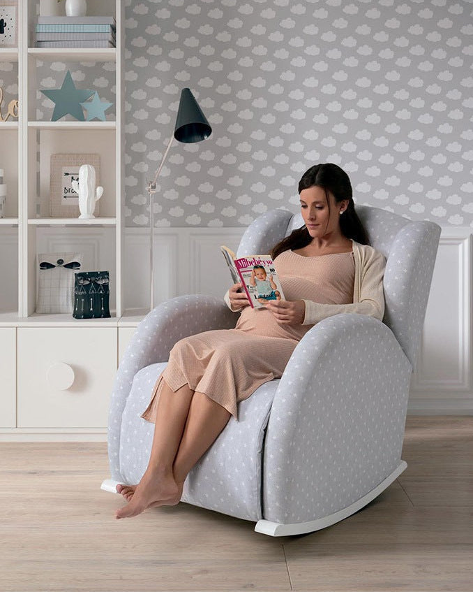 Woman reading a book in a modern armchair in a stylish room.