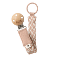 Woven pacifier clip with blush-and-ivory strap, BIBS tag, and metal clasp