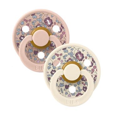 Pair of blush floral latex baby pacifiers with round shields and shield loops