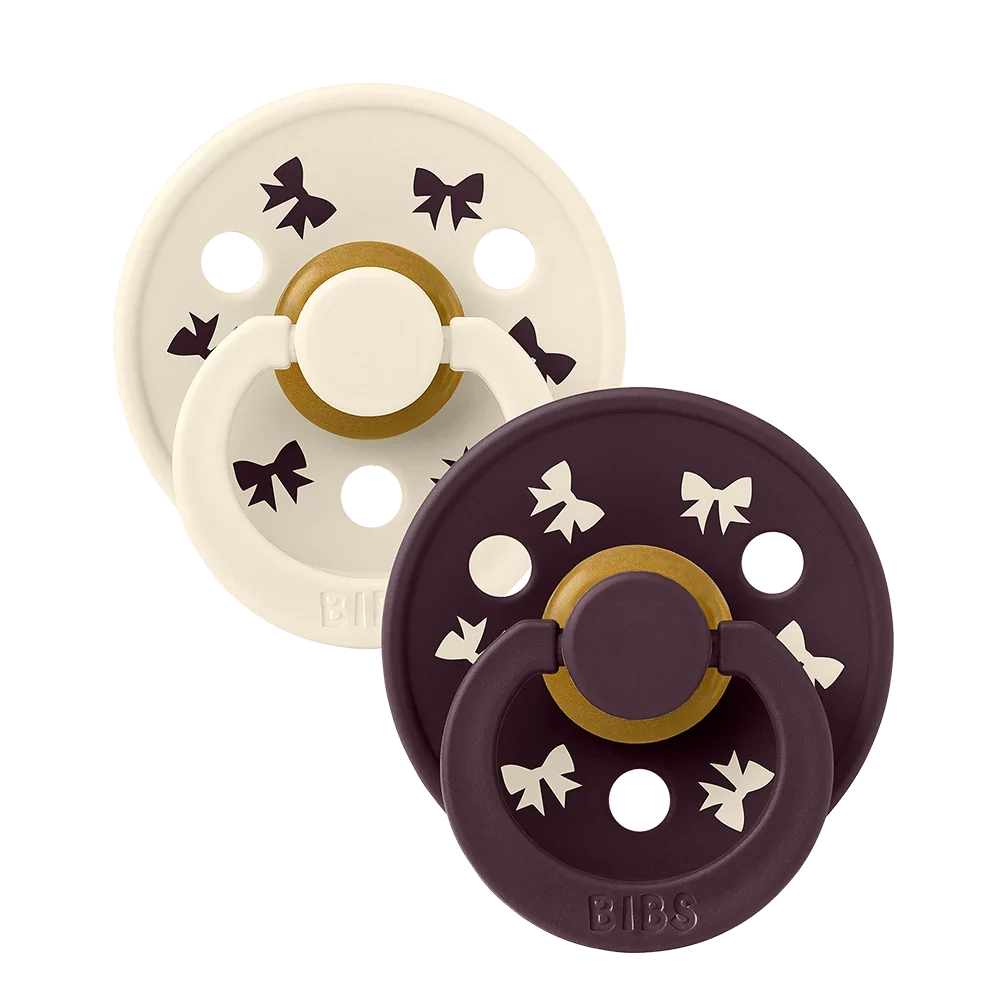 2-pack latex pacifiers, ivory and plum with star accents and shield base