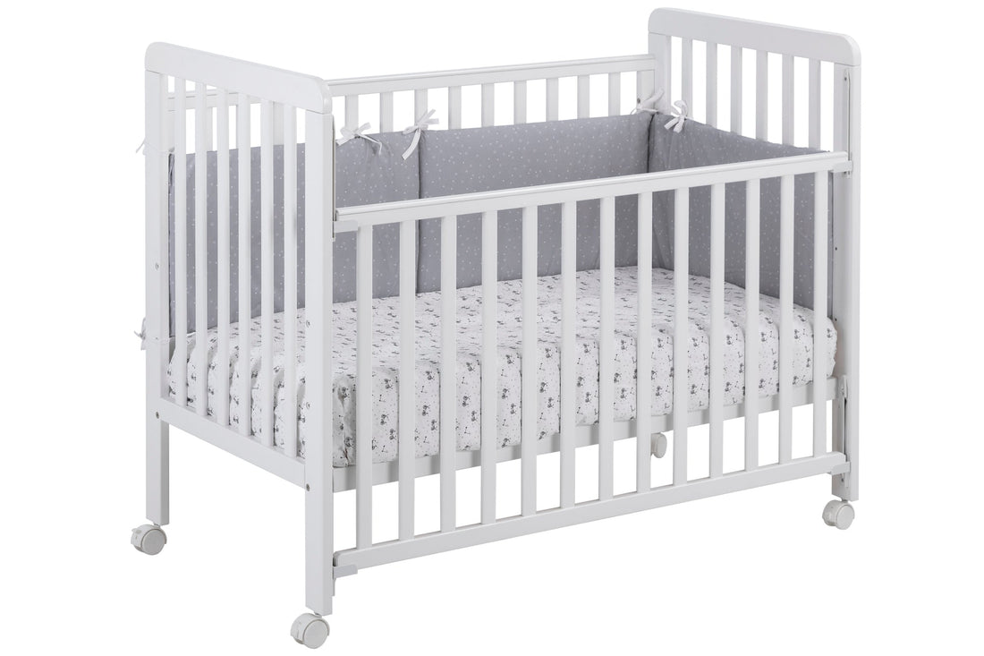 IKID Bari white baby cot 60x120cm with drop-side mechanism and beechwood frame