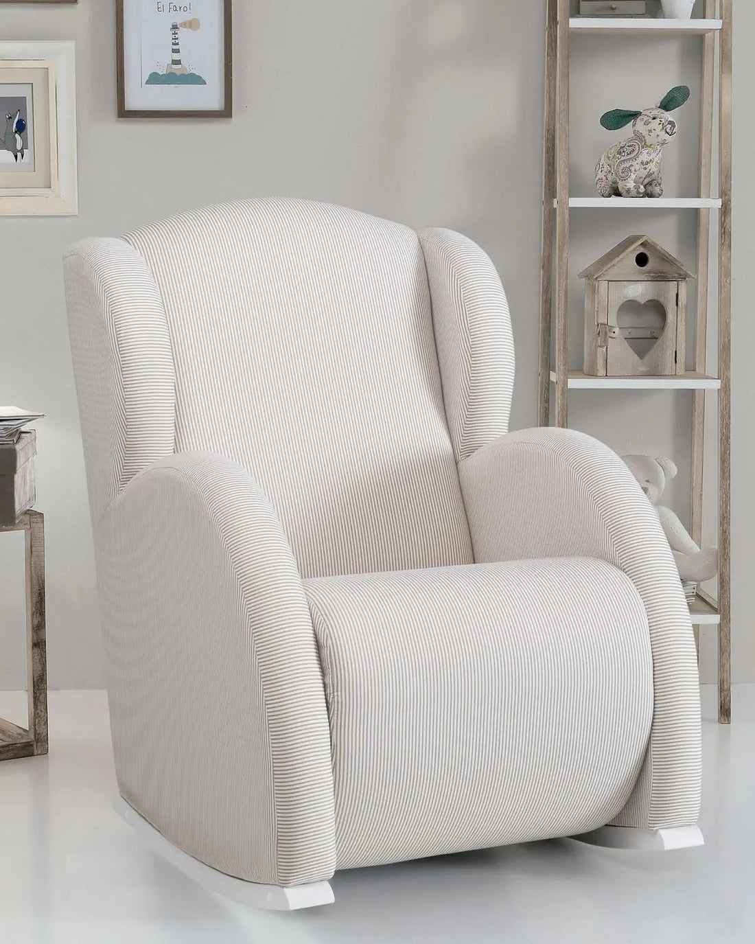 White armchair in a room with a bookshelf and decorative items.