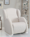 White armchair in a room with a bookshelf and decorative items.