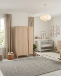 Nursery room with wooden wardrobe, crib, and rocking chair.