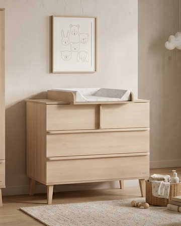 Nursery room with wooden furniture including a wardrobe, dresser, and crib.