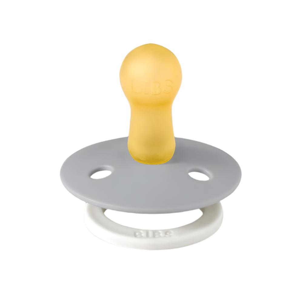 Two pacifiers with white loop handles; sage and light gray shields with warm center