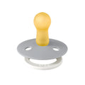 Pacifier with pale yellow shield and gray-green round base with two air holes